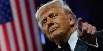 Donald Trump defies market tumult as tariffs take effect