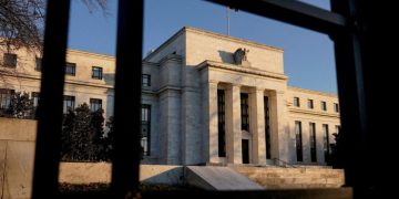 Federal Reserve cuts outlook for US economy but holds interest rates steady