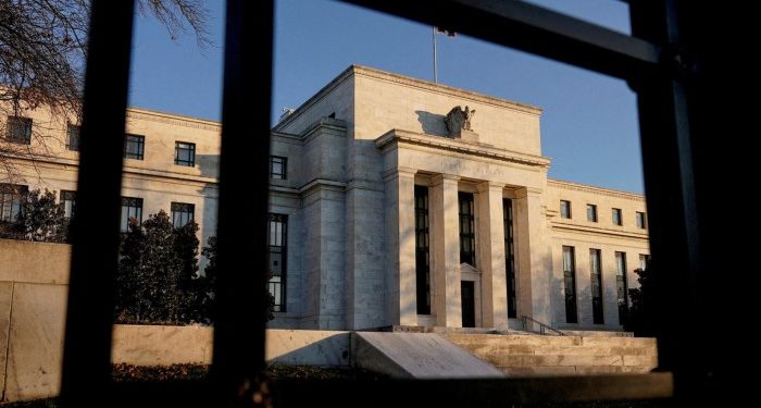 Federal Reserve cuts outlook for US economy but holds interest rates steady