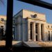Federal Reserve cuts outlook for US economy but holds interest rates steady